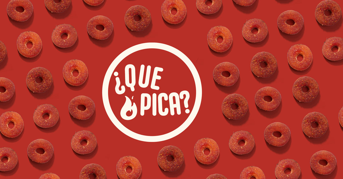 Repeating pattern of Chile Peach Rings on a red background with primary Que Pica Candy logo in white, in the middle of the candy