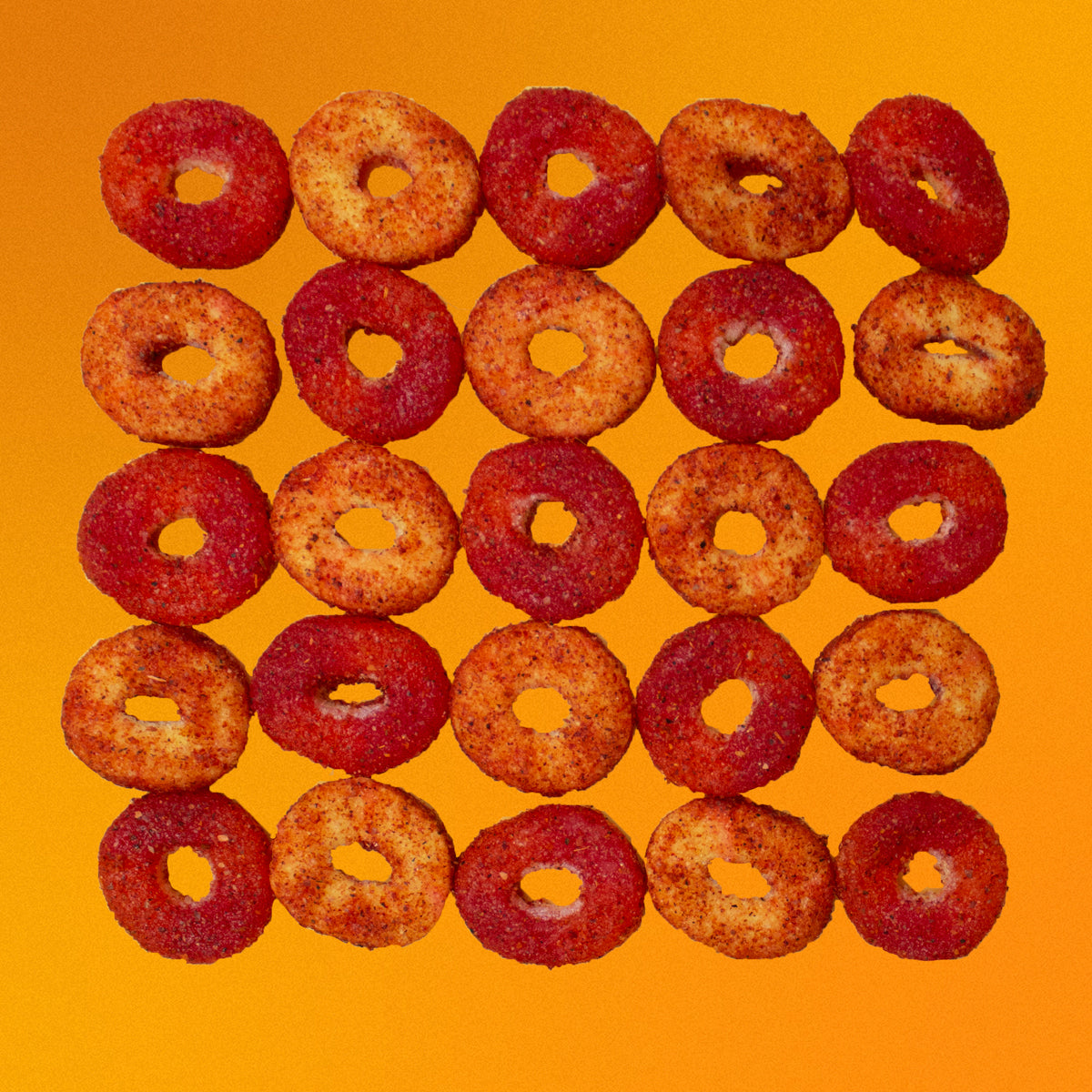 Repeating pattern of peach rings dulces enchilados in front of yellow background